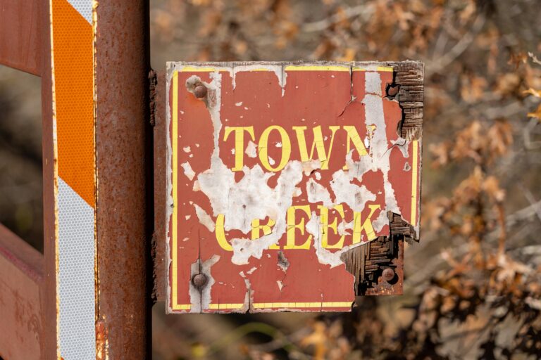 A faded sign that used to say "Town Creek"